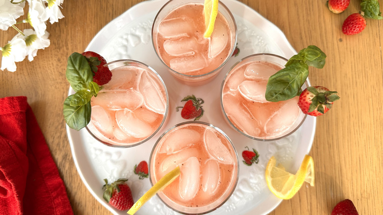 pink lemonade garnished with strawberries and basil