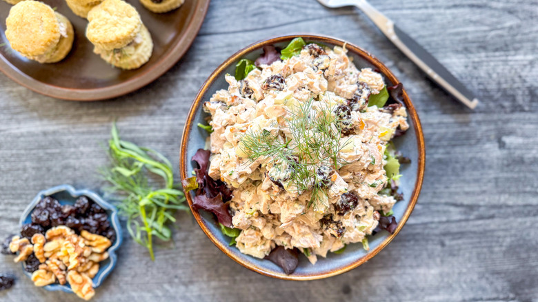 Triple anise chicken salad with fennel fronds and biscuits on serving plate