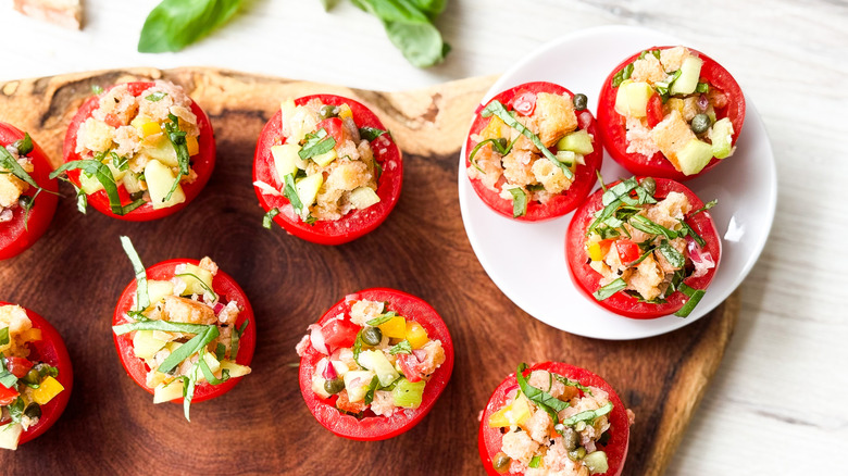 Bite-sized panzanella stuffed tomatoes on serving platter
