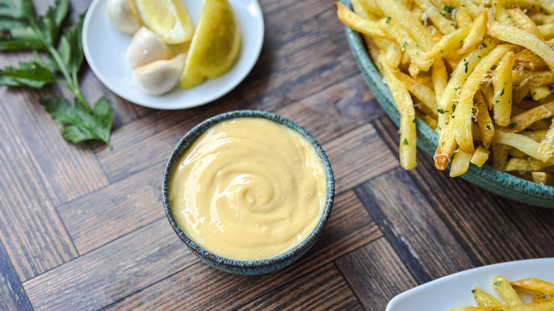 homemade double truffle aioli with french fries and lemon wedges