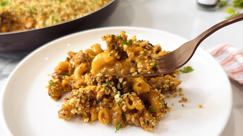 Hamburger Helper serving on plate with forkful being removed