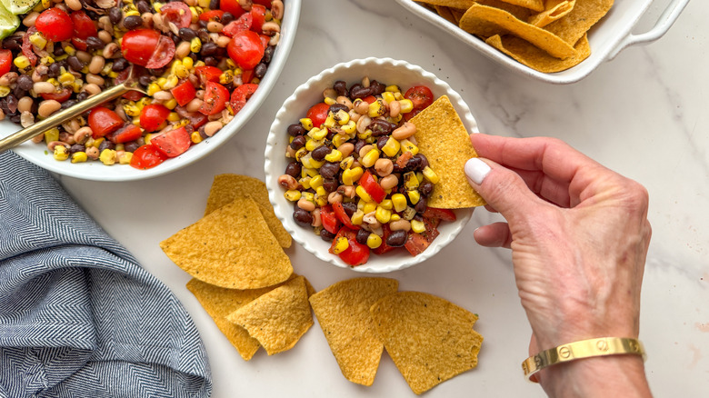 hand dipping a chip in