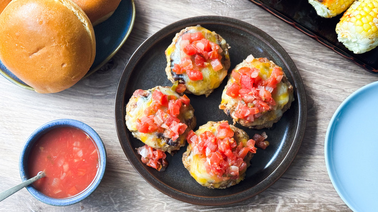 Juicy 3-ingredient tex-mex turkey burgers on serving platter with salsa and buns