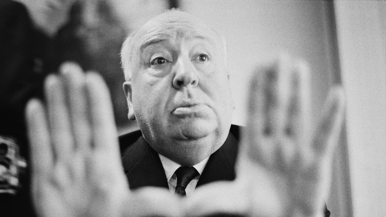 Black and white photo of Alfred Hitchcock framing the camera with his hands
