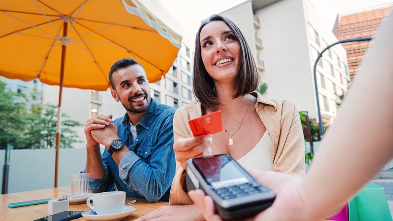 A couple of diners paying for a restaurant meal